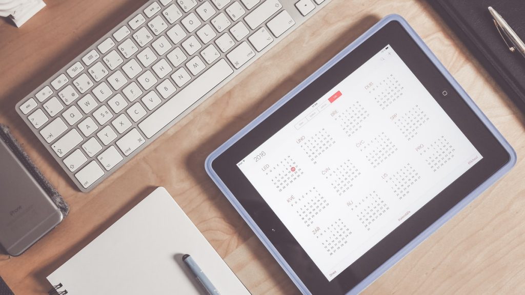calendar on iPad next to computer keyboard