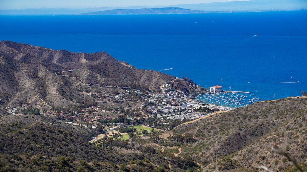 Image of bright blue water and mountains.