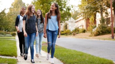 teen girls walking neighborhood