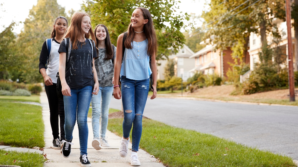 teen girls walking neighborhood